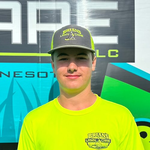 Photo of Brian's Lawn Care employee next to service truck.